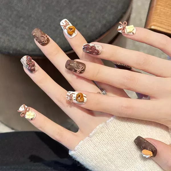 A set of handmade nail studs in various elegant designs, perfect for adding a sophisticated touch to your nail art.