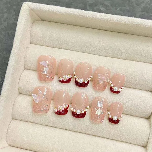 A set of handmade nail studs in various elegant designs, perfect for adding a sophisticated touch to your nail art.