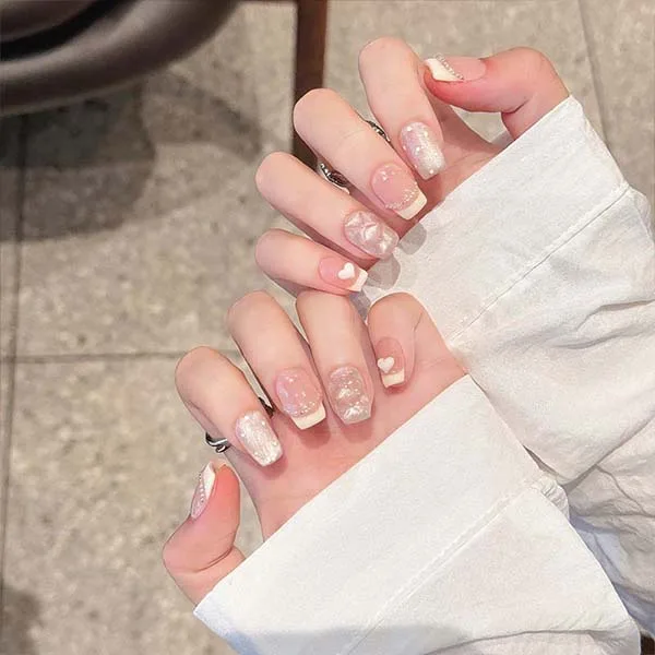 A set of handmade nail studs in various elegant designs, perfect for adding a sophisticated touch to your nail art.