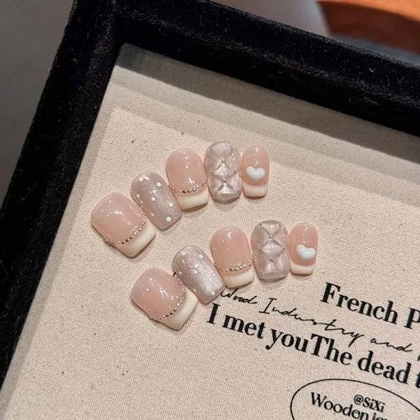 A set of handmade nail studs in various elegant designs, perfect for adding a sophisticated touch to your nail art.