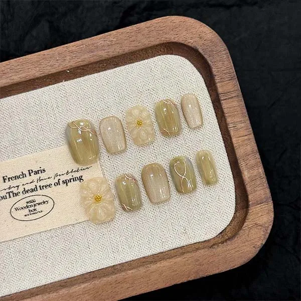 A set of handmade nail studs in various elegant designs, perfect for adding a sophisticated touch to your nail art.