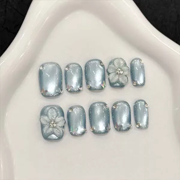 A set of handmade nail studs in various elegant designs, perfect for adding a sophisticated touch to your nail art.