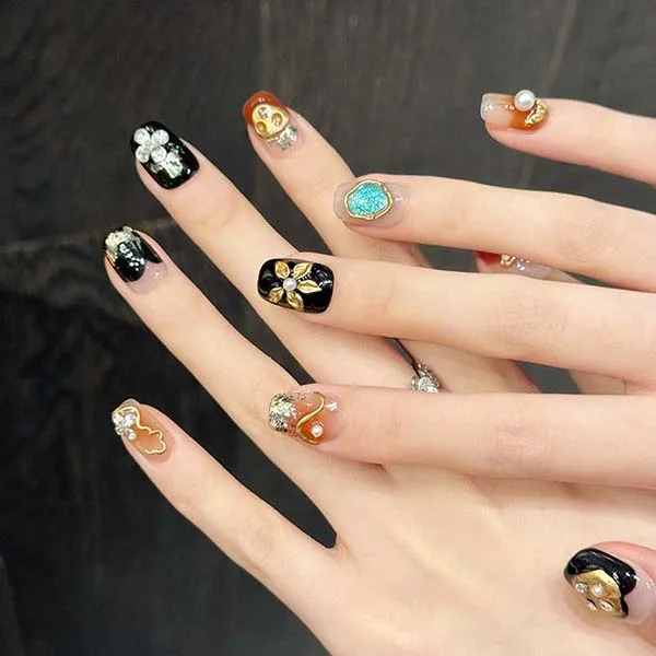 A set of handmade nail studs in various elegant designs, perfect for adding a sophisticated touch to your nail art.