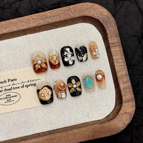 A set of handmade nail studs in various elegant designs, perfect for adding a sophisticated touch to your nail art.