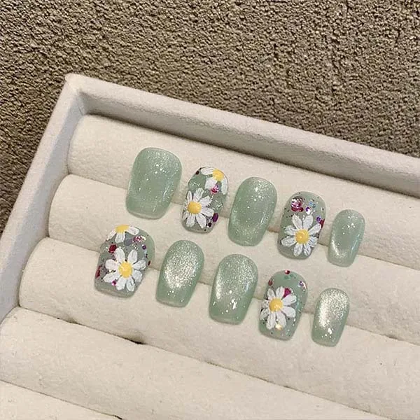 A set of handmade nail studs in various elegant designs, perfect for adding a sophisticated touch to your nail art.